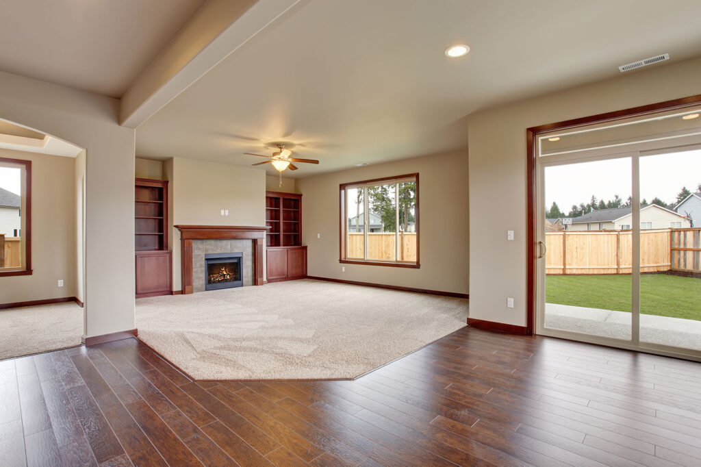Open-concept living room with hardwood flooring and an area rug | Direct Carpet Unlimited